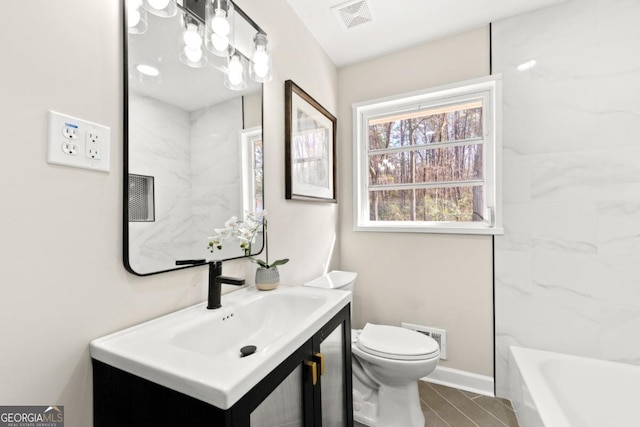 bathroom featuring vanity and toilet