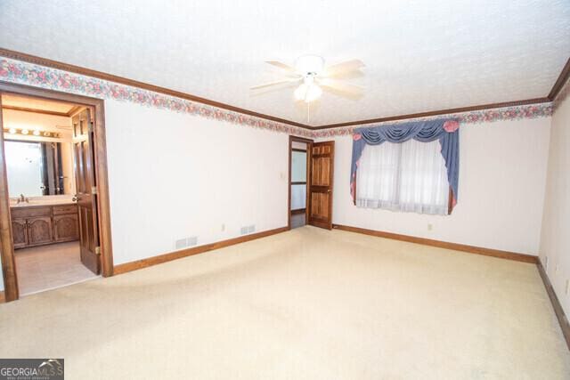 interior space featuring light colored carpet and ceiling fan