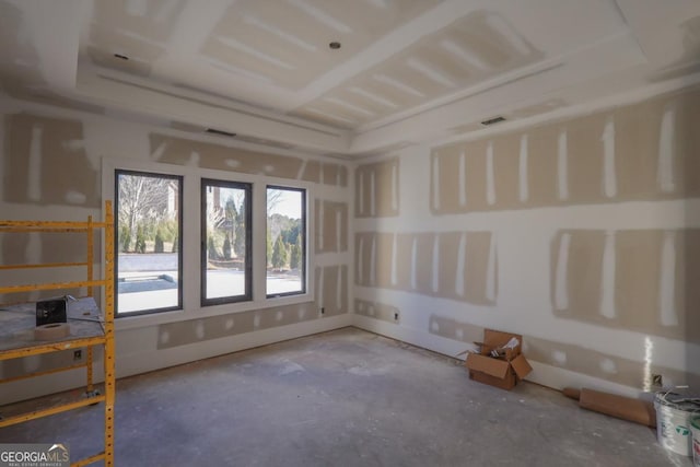 unfurnished room featuring plenty of natural light and concrete floors