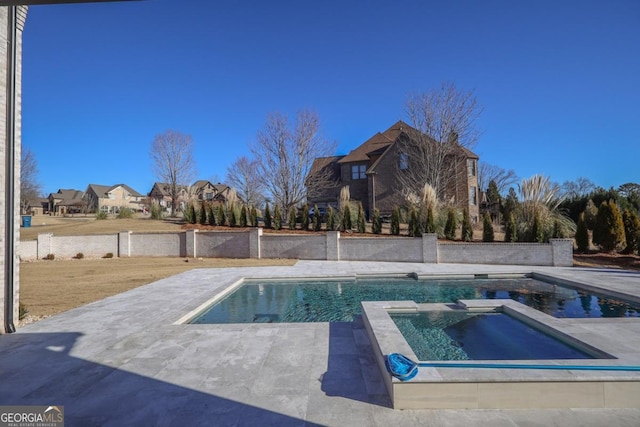 view of swimming pool with an in ground hot tub