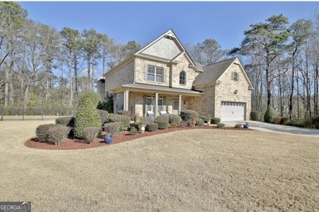 craftsman house featuring covered porch, a garage, and a front lawn