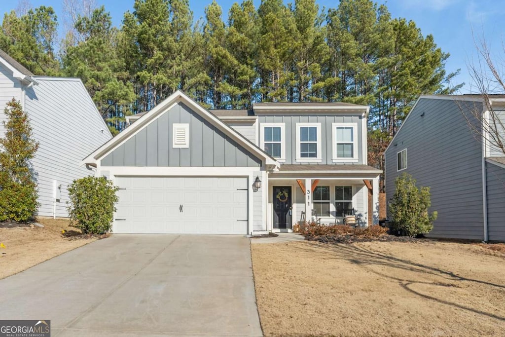 view of front of property with a garage and covered porch