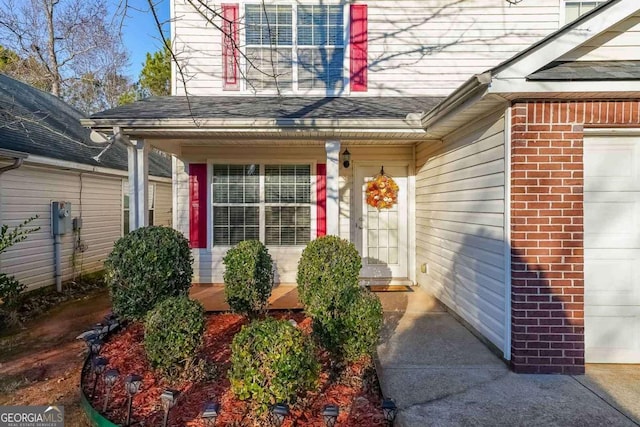 view of exterior entry featuring a garage