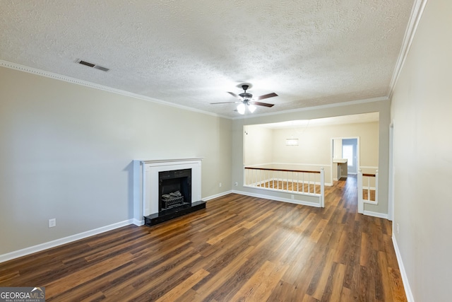 unfurnished living room with crown molding, ceiling fan, dark wood-type flooring, and a textured ceiling