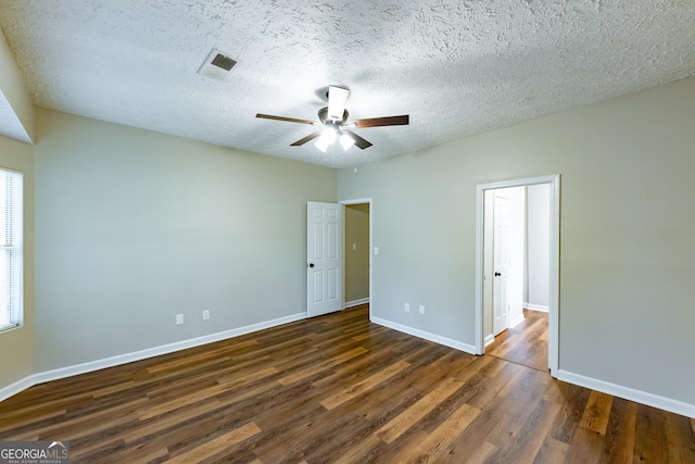 unfurnished bedroom featuring dark hardwood / wood-style flooring, a textured ceiling, and ceiling fan