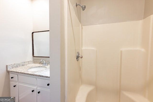 bathroom with vanity and a shower