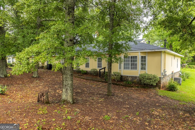 view of side of property with cooling unit