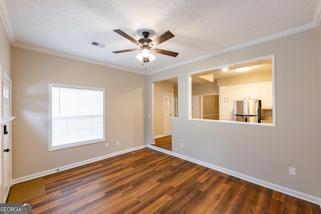 spare room featuring ceiling fan, dark hardwood / wood-style flooring, a textured ceiling, and ornamental molding