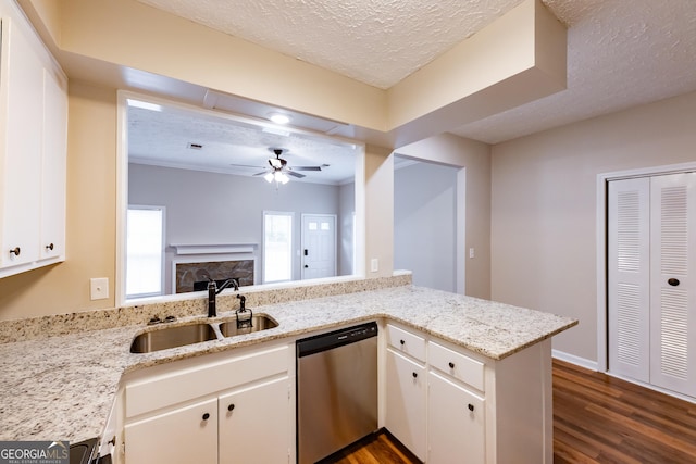 kitchen featuring dishwasher, white cabinetry, kitchen peninsula, and sink