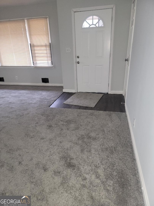 entryway with dark colored carpet