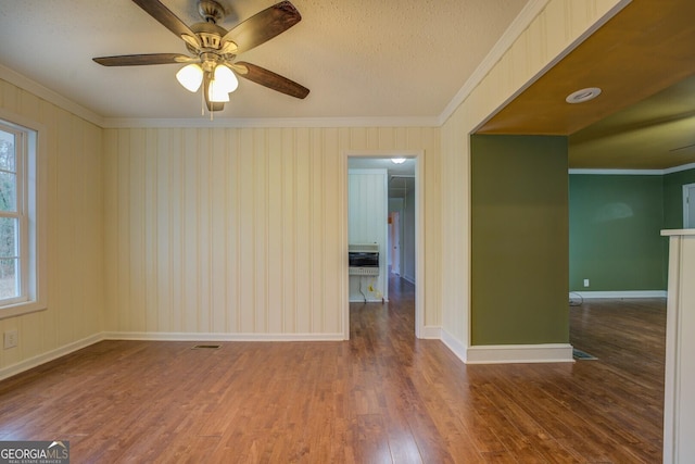 12178 Brown Bridge Rd, Covington, GA 30016 - unfurnished room featuring crown molding, wood finished floors, plenty of natural light, ceiling fan, and a textured ceiling