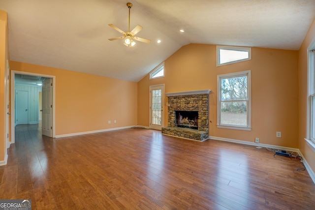 12178 Brown Bridge Rd, Covington, GA 30016 - unfurnished living room featuring ceiling fan, wood finished floors, a stone fireplace, and high vaulted ceiling