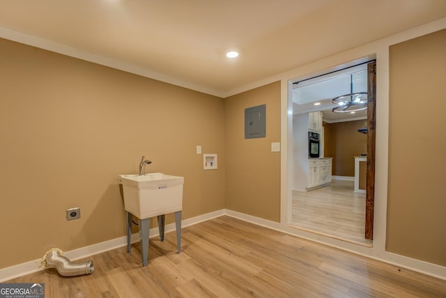 12178 Brown Bridge Rd, Covington, GA 30016 - laundry room with electric dryer hookup, electric panel, light wood-style flooring, hookup for a washing machine, and recessed lighting