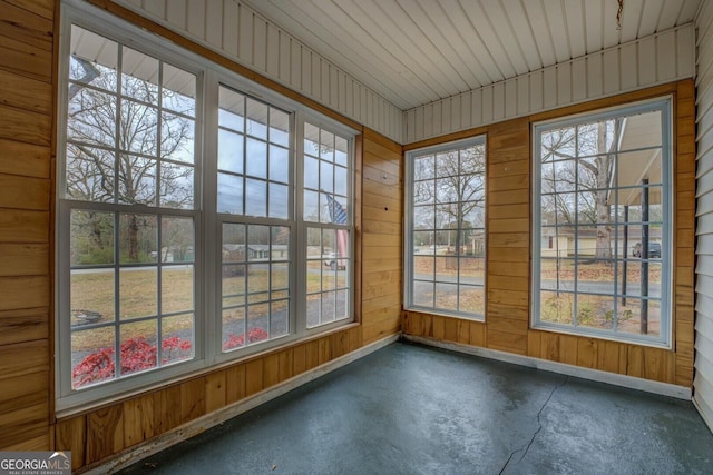 12178 Brown Bridge Rd, Covington, GA 30016 - unfurnished sunroom with unfinished concrete flooring and wood walls
