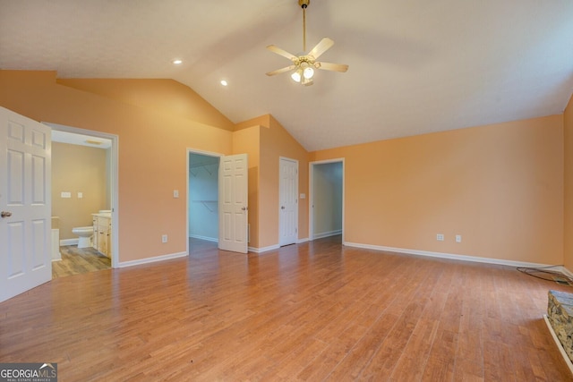 12178 Brown Bridge Rd, Covington, GA 30016 - unfurnished bedroom with vaulted ceiling, a spacious closet, light wood-style flooring, ensuite bathroom, and ceiling fan