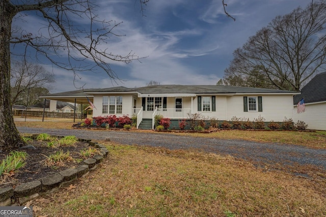 view of front facade with a carport and covered porch