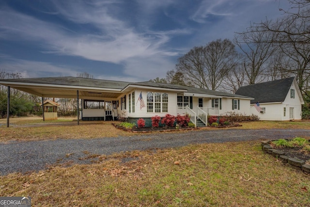 view of front of home featuring a carport and driveway