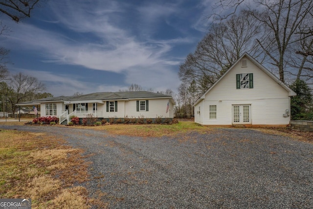 12178 Brown Bridge Rd, Covington, GA 30016 - view of front of property featuring french doors, a porch, and gravel driveway