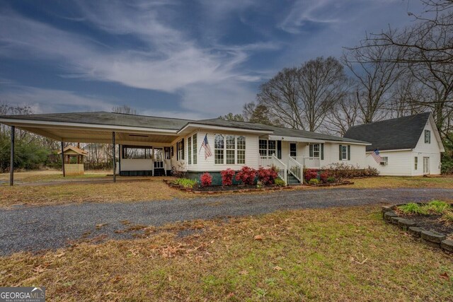 12178 Brown Bridge Rd, Covington, GA 30016 - view of front of house featuring a front lawn, driveway, and a carport
