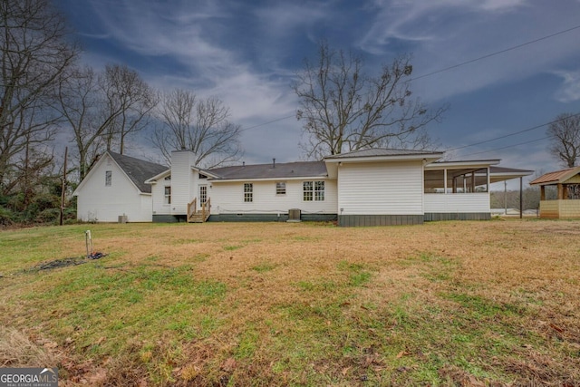 12178 Brown Bridge Rd, Covington, GA 30016 - back of property with a sunroom, a lawn, a chimney, and entry steps