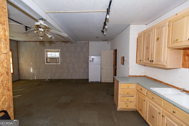 kitchen with cooling unit, light countertops, freestanding refrigerator, light brown cabinetry, and concrete block wall