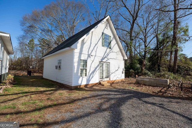 view of side of property with french doors and cooling unit