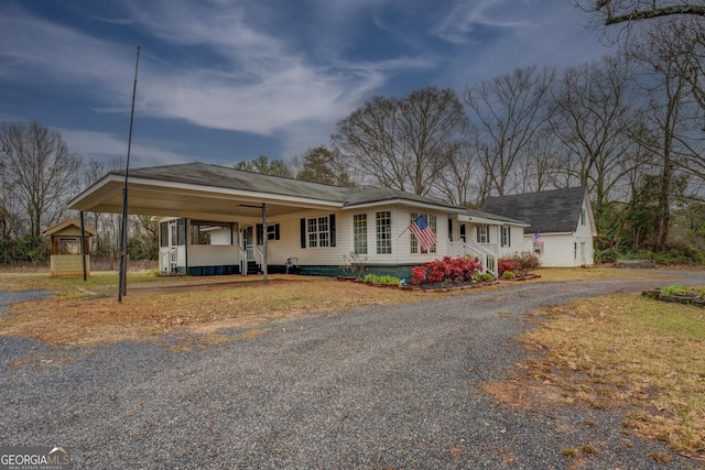 view of front of property featuring an attached carport and driveway