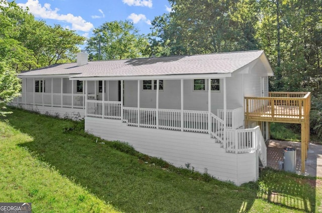 back of house with a lawn