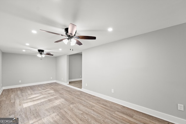 spare room with ceiling fan and light wood-type flooring