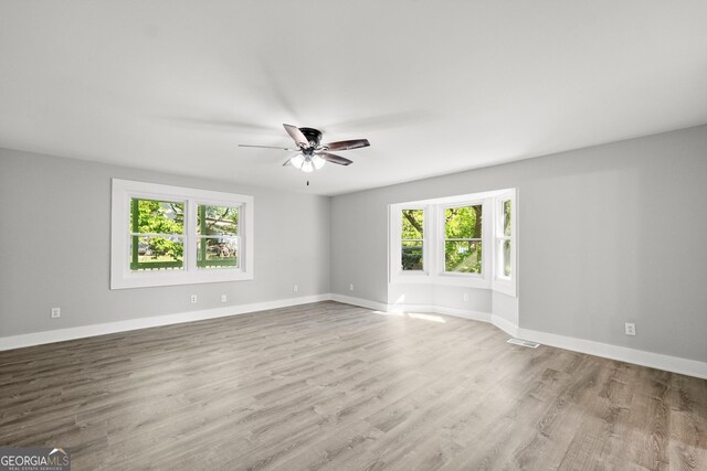 empty room featuring ceiling fan and light wood-type flooring