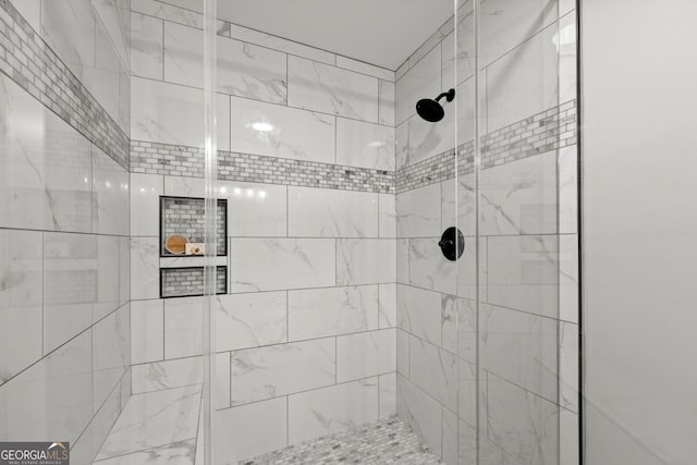 bathroom with tiled shower