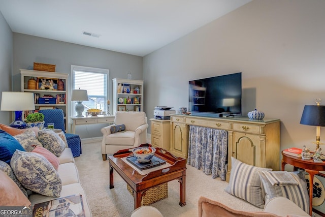 carpeted living area with visible vents