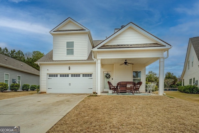 view of front of house with a garage, a shingled roof, a ceiling fan, driveway, and a front lawn