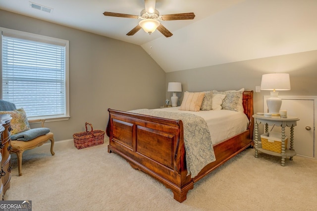 bedroom featuring lofted ceiling, light colored carpet, ceiling fan, and visible vents