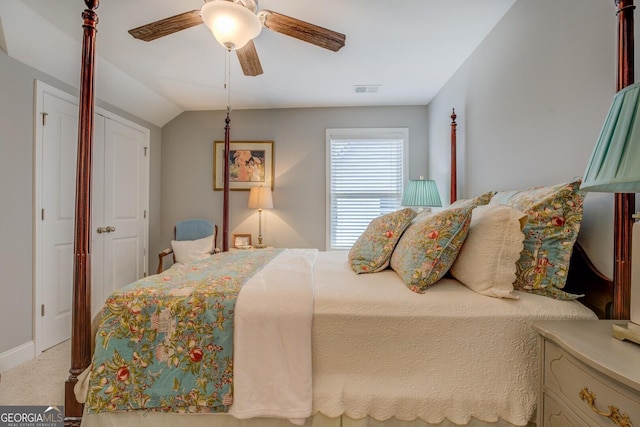 bedroom with lofted ceiling, a ceiling fan, visible vents, and carpet flooring