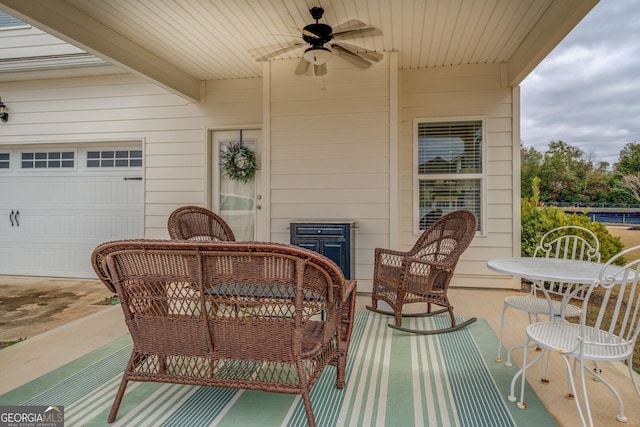 exterior space with a ceiling fan and a garage