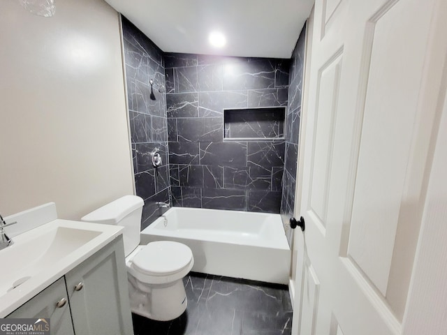 full bathroom with toilet, vanity, and tiled shower / bath