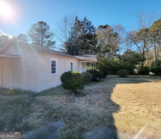 view of side of property with a yard