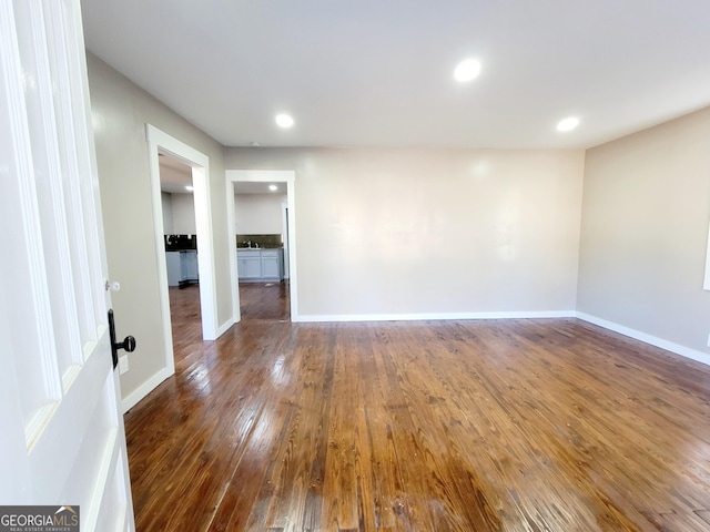 empty room featuring dark hardwood / wood-style floors and sink