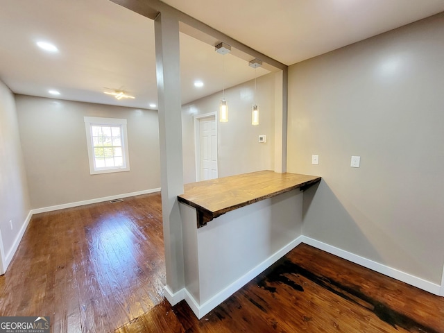 basement with dark hardwood / wood-style flooring