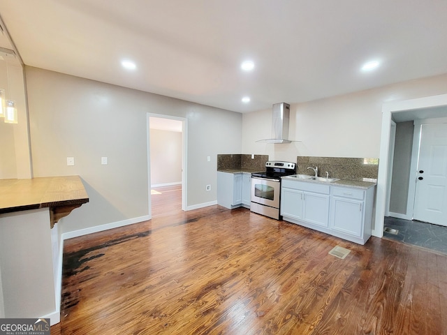 kitchen featuring wall chimney exhaust hood, sink, dark hardwood / wood-style floors, white cabinetry, and stainless steel range with electric cooktop