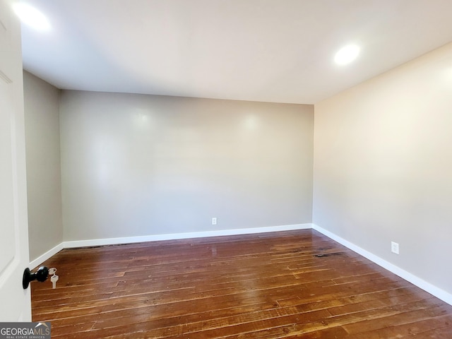 spare room featuring dark hardwood / wood-style flooring