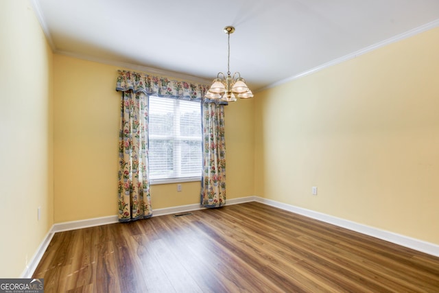 spare room featuring crown molding, a chandelier, and hardwood / wood-style flooring