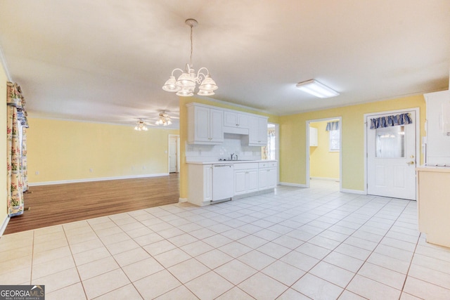 kitchen featuring white dishwasher, white cabinetry, tasteful backsplash, and light tile patterned flooring