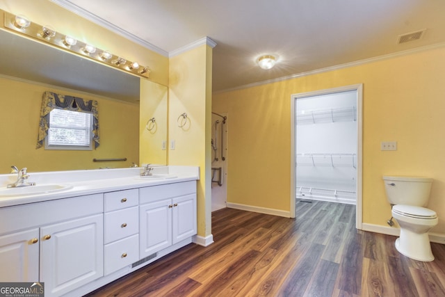 bathroom featuring vanity, hardwood / wood-style flooring, toilet, and ornamental molding