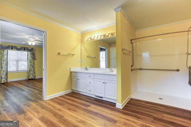 bathroom featuring ceiling fan, crown molding, vanity, and hardwood / wood-style flooring