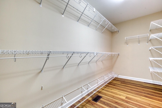 spacious closet featuring hardwood / wood-style flooring