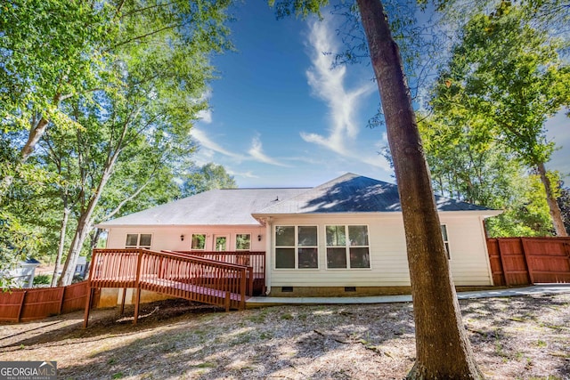 back of house featuring a wooden deck