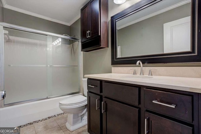 full bathroom with vanity, shower / bath combination with glass door, crown molding, tile patterned flooring, and toilet