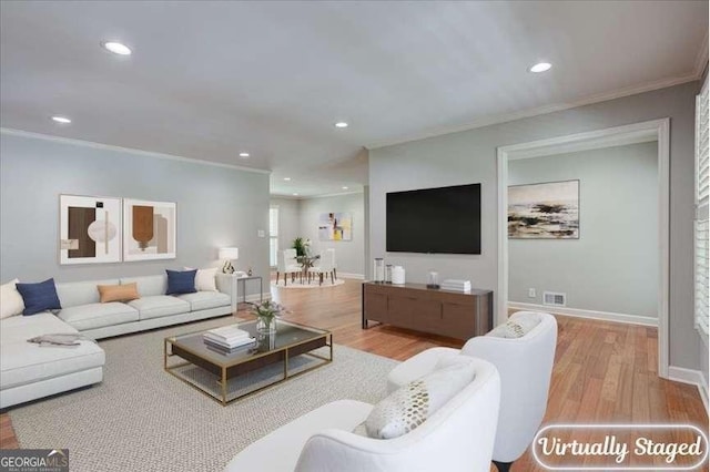 living room featuring light hardwood / wood-style floors and crown molding